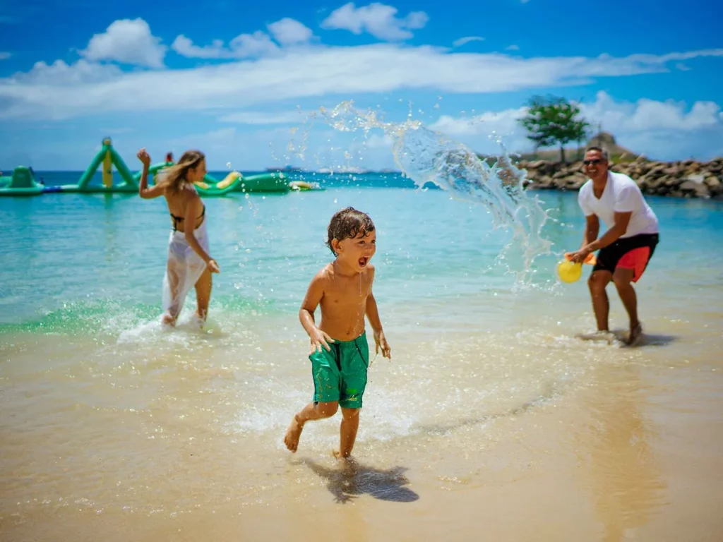 Family splashing and playing on the beach