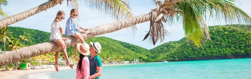 caribbean-oicture-of-kids-sitting-on-palm-tree-and-family-together-on-beach