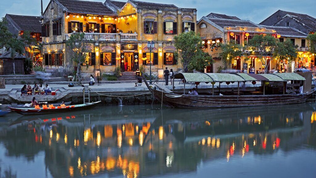 View looking on water town of Hoi an, in twilight of night city lights and lanterns reflecting on the water Luxury Travel Destinations