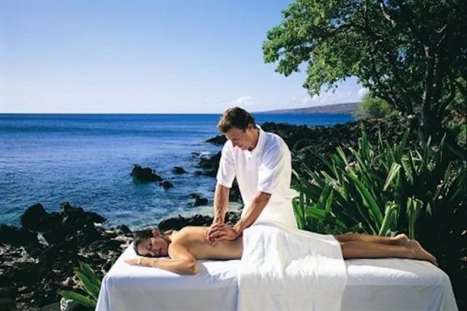 woman getting massage at top of island coast