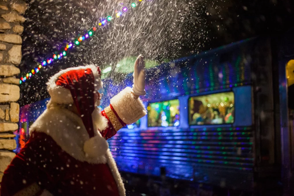 santa clause waving to children on a train 10 best christmas vacation locations