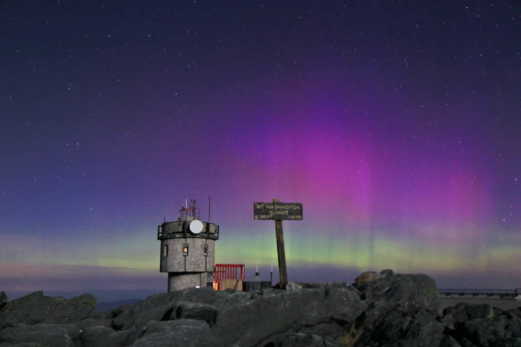 A moonlit Mount Washington Observatory instrument tower and the Moun