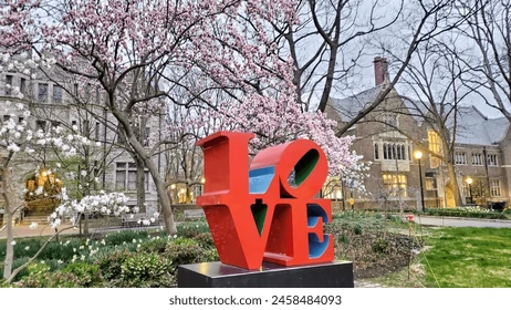 city brotherly love philadelphia, picture of love sculpture blowing threes and historic homes in the background