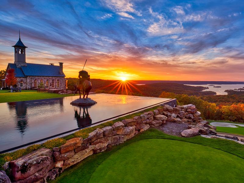 Top of the Rock Branson Missouri looking out over the lake during sunset with icon statue of Indian on horse with spear and looking down into the water